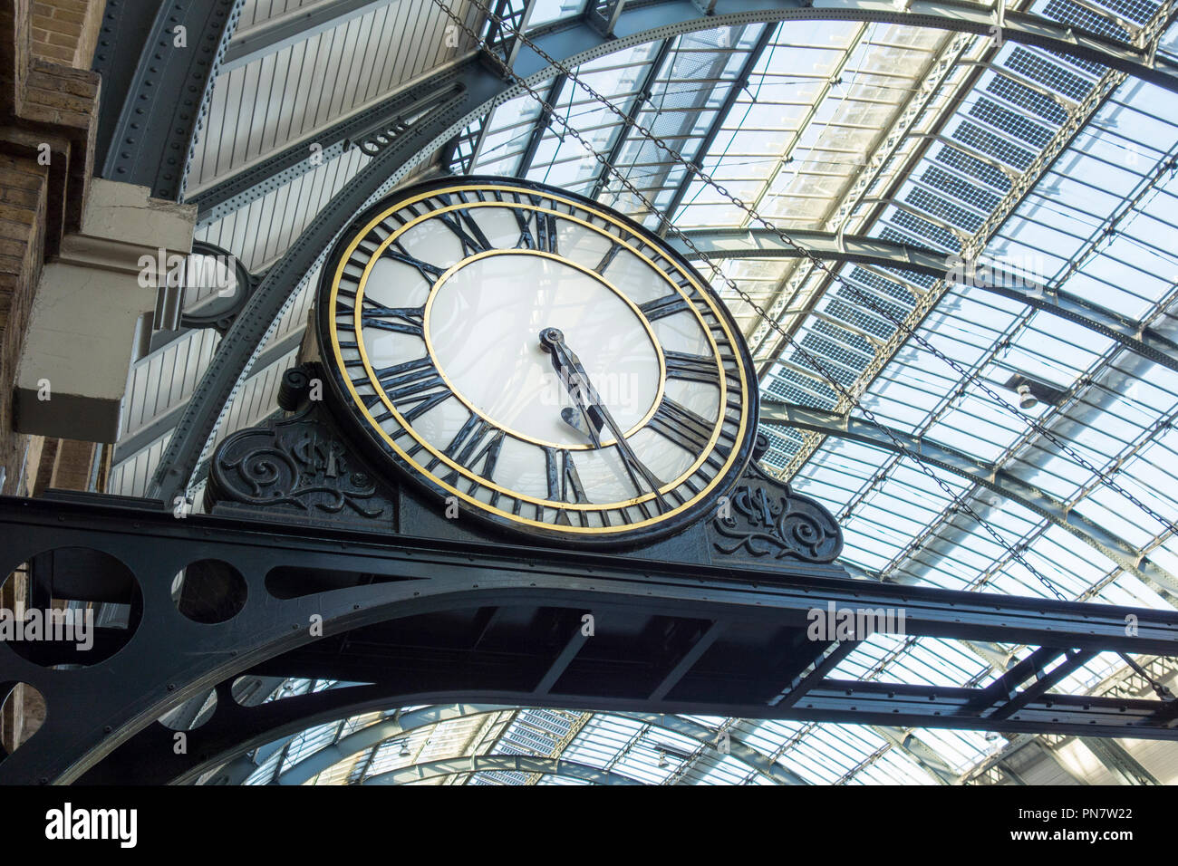 Restored projecting platform clock at King's Cross railway station, London, UK Stock Photo