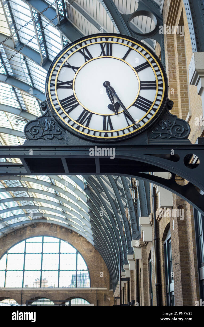 Restored projecting platform clock at King's Cross railway station, London, UK Stock Photo