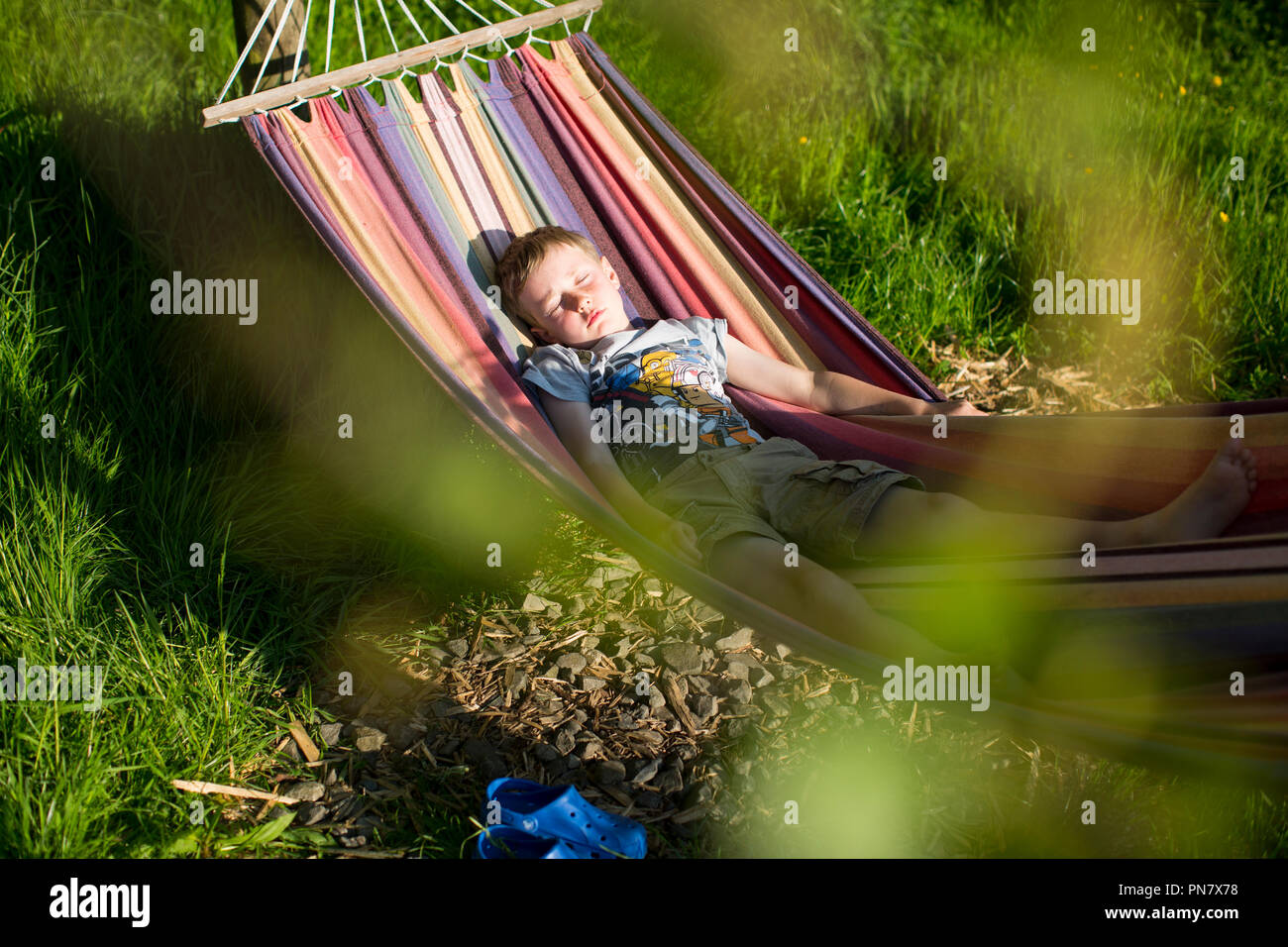 A young boy lying in a hammock Stock Photo - Alamy