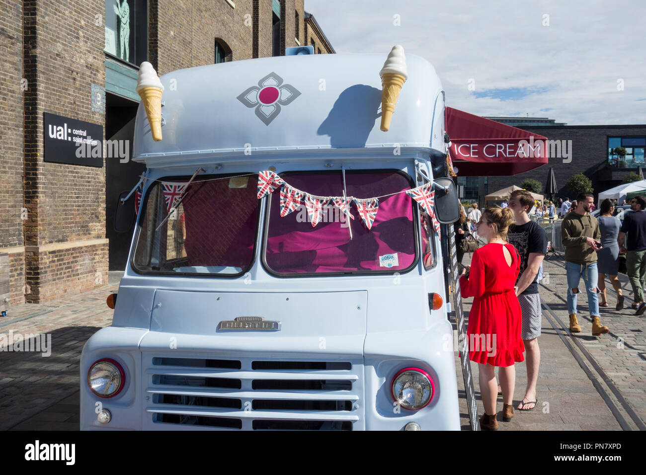 A young couple buying an ice cream from Ruby Violet's ice cream van in Granary Square, King's Cross, Camden, London, N1, UK Stock Photo