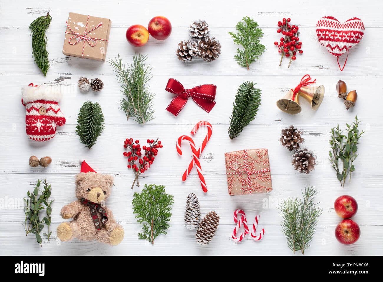 Christmas gifts, pine branches, apples and ribbon on wooden table.Top view,flat lay. Stock Photo