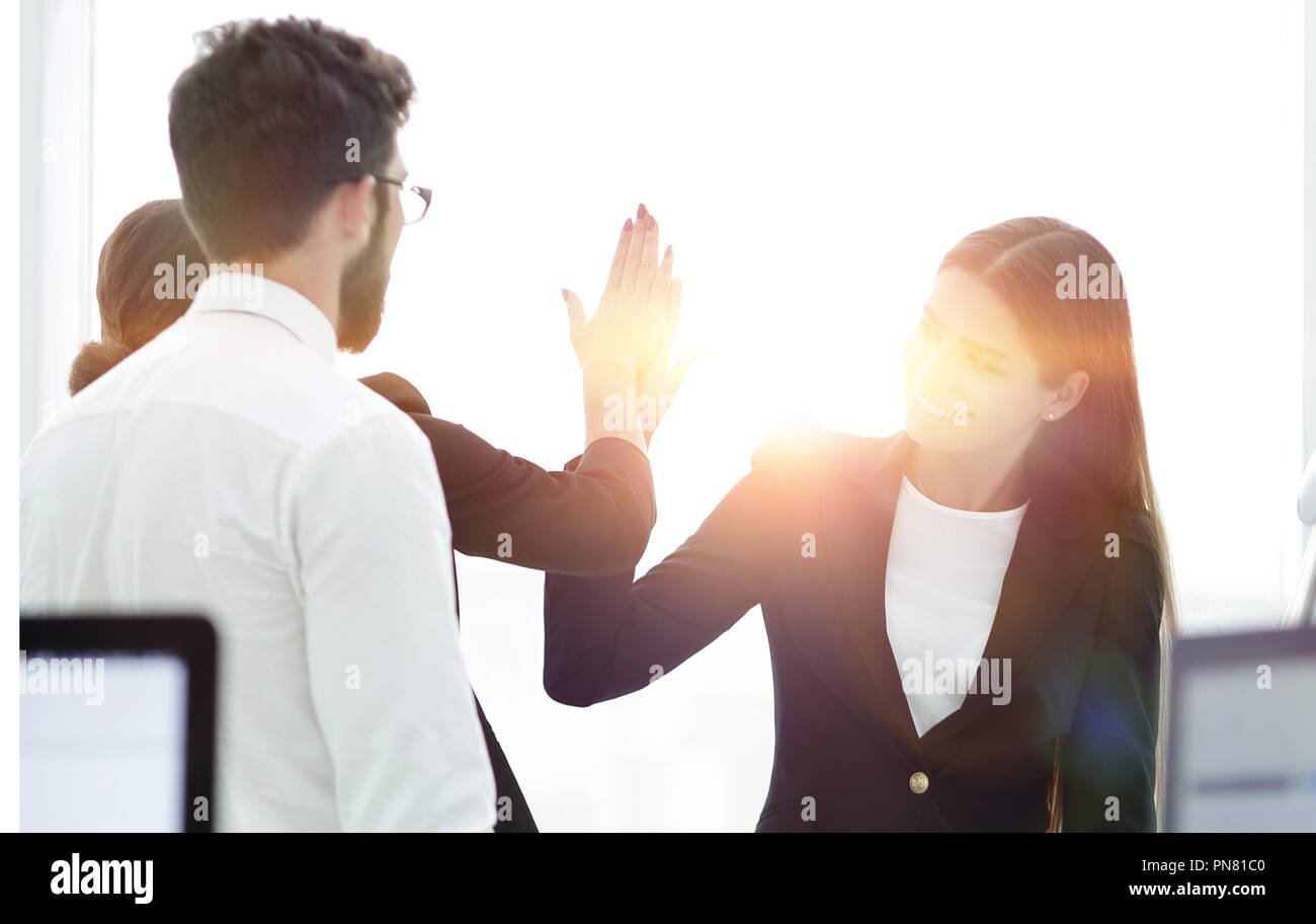 employees giving each other high five Stock Photo - Alamy