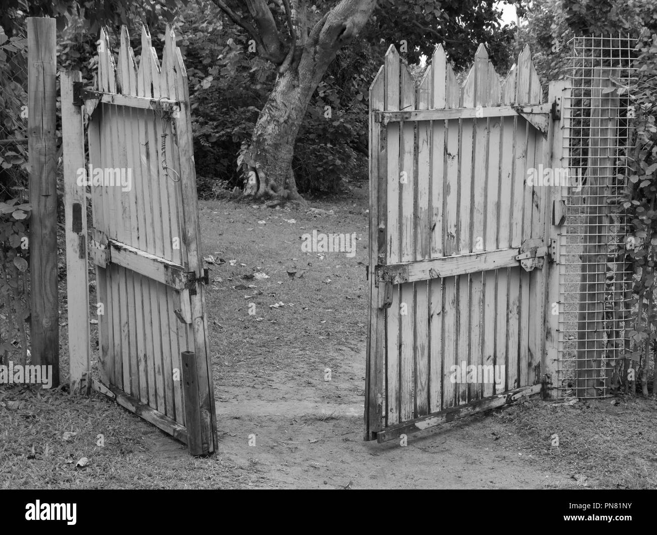 Black and white, monochrome photo of an open wooden gate Stock Photo