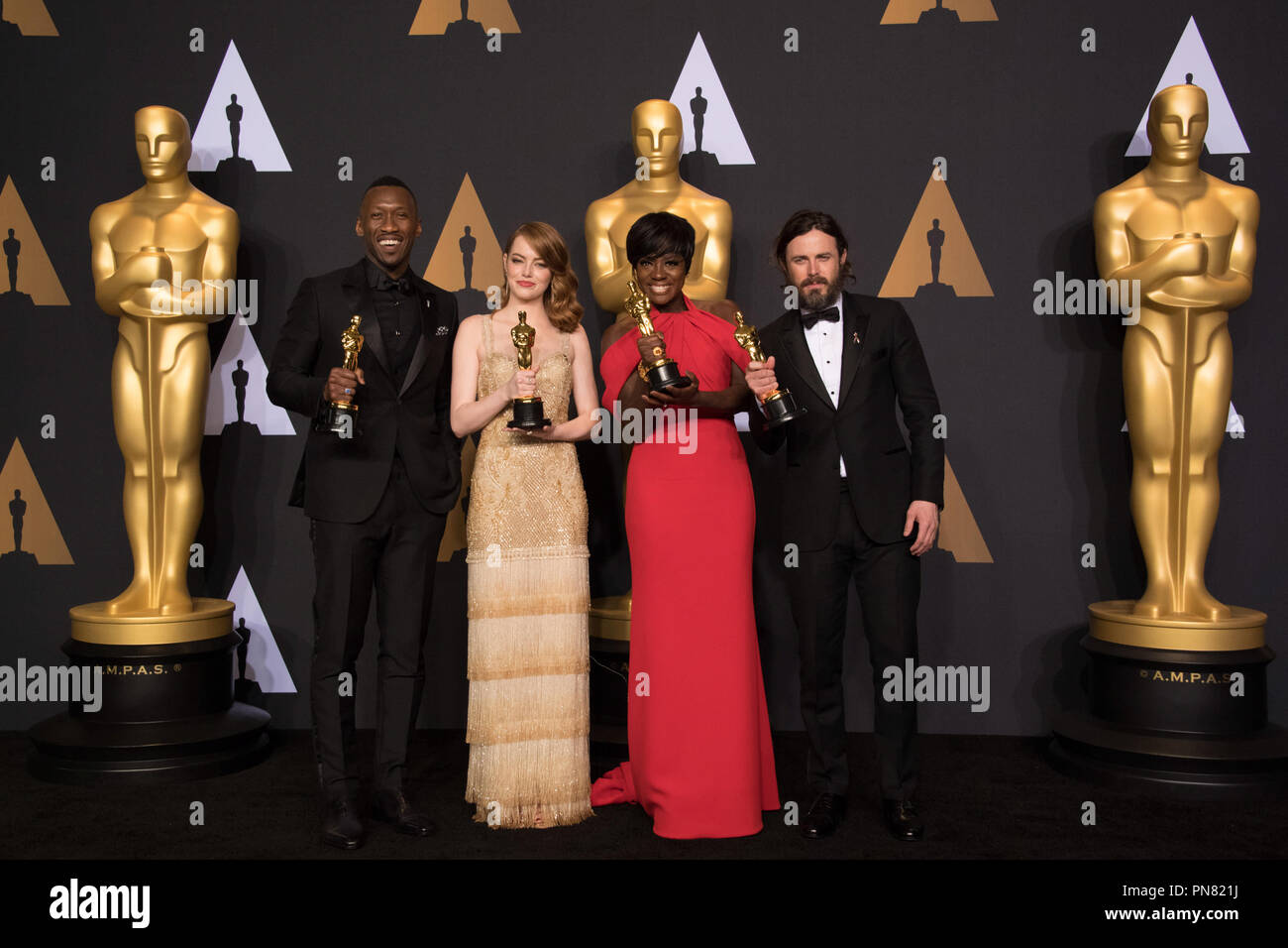 Backstage posing with their Oscars®, Mahershala Ali, Actor in a Supporting Role; Emma Stone, Actress in a Leading Role; Viola Davis, Actress in a Supporting Role; and Casey Affleck, Actor in a Leading Role backstage during The 89th Oscars® at the Dolby® Theatre in Hollywood, CA on Sunday, February 26, 2017.  File Reference # 33242 554THA  For Editorial Use Only -  All Rights Reserved Stock Photo