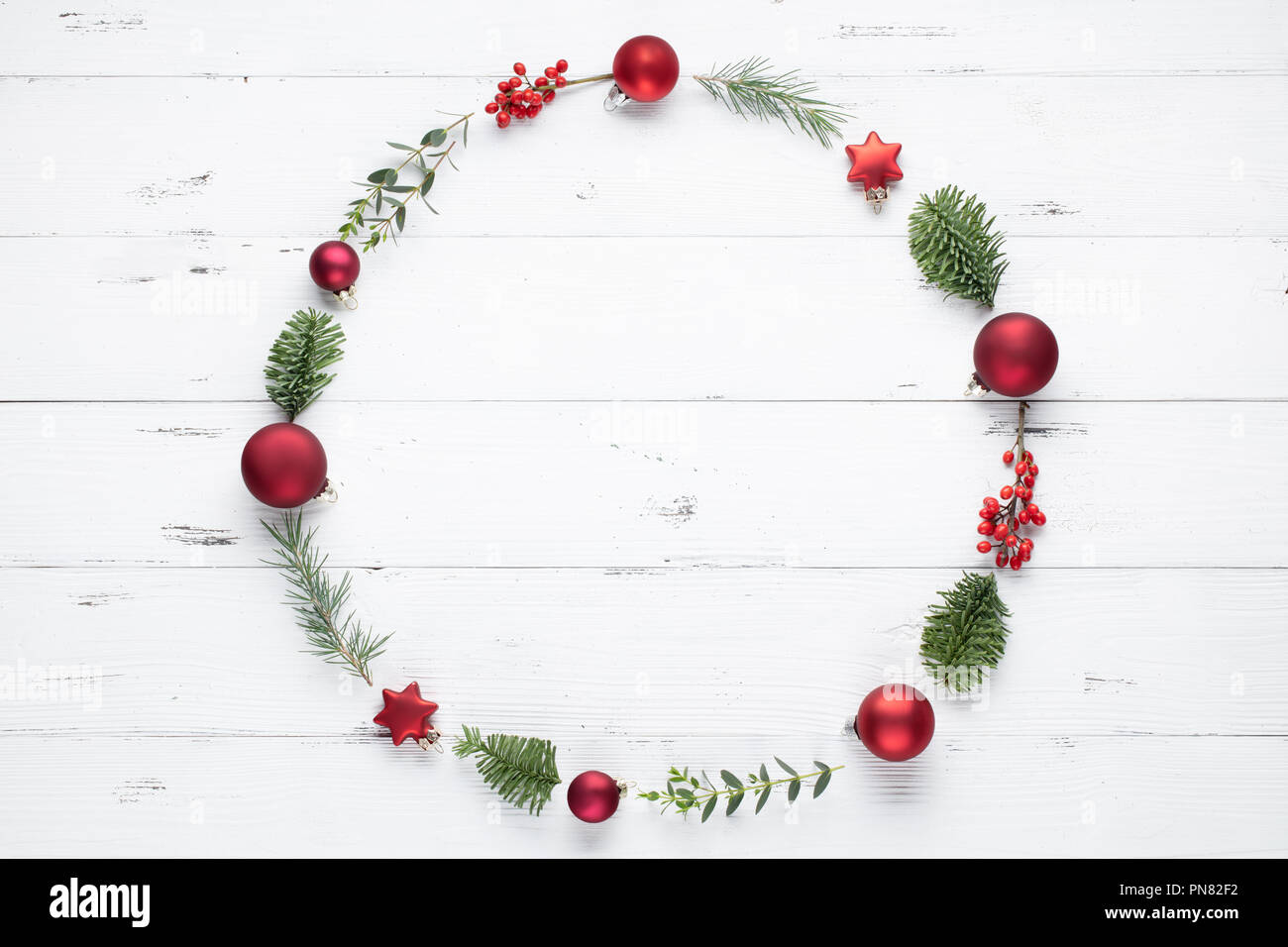 Christmas wreath made of fir branches, balls and eucalyptus on white background. Flat lay Stock Photo