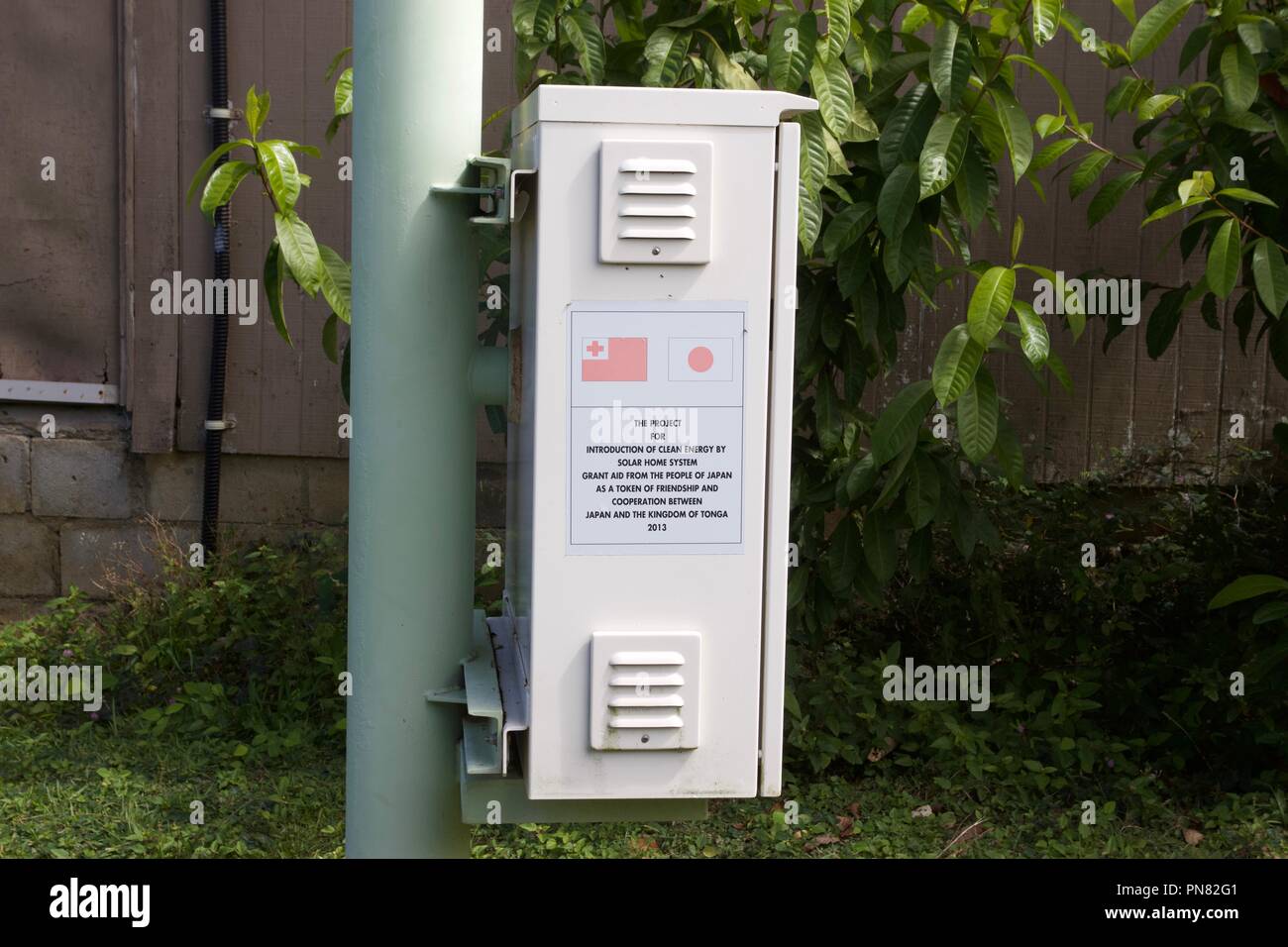 Solar panels inside a village in Tonga have been funded by Japan as part of Introduction of clean energy by Solar Home System Stock Photo