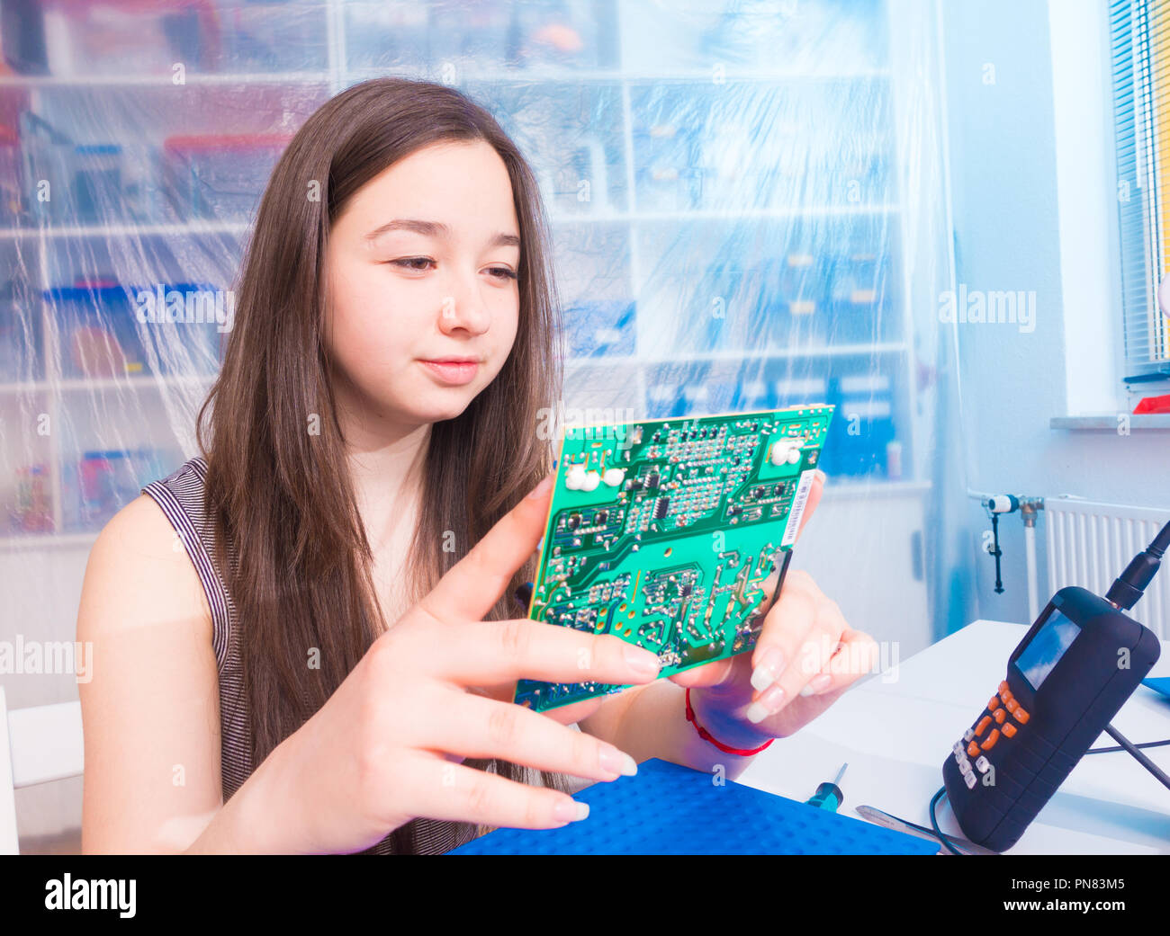 Young woman create digital electronic project with circuit board PCB in  laboratory Stock Photo - Alamy