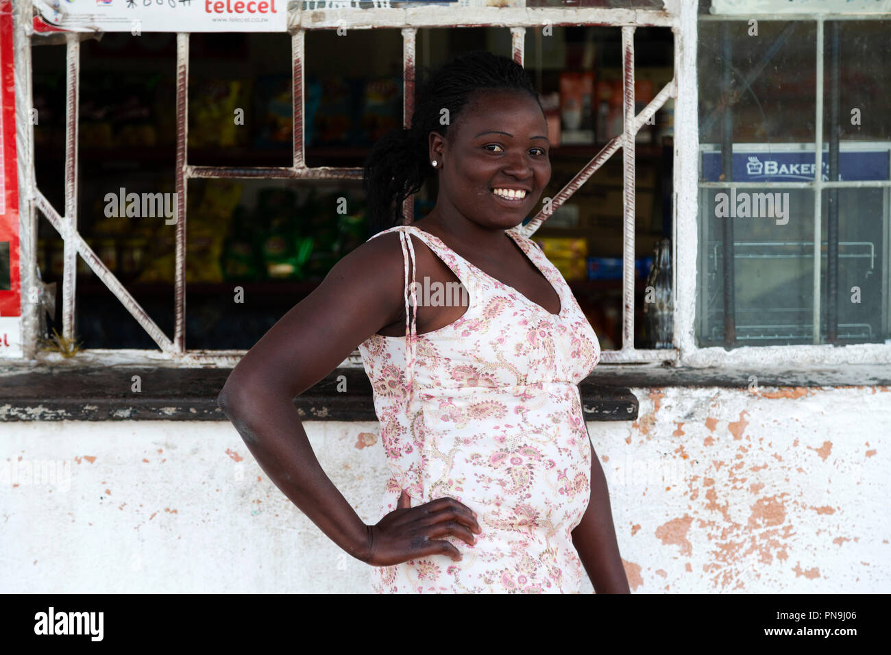 Woman by the counter of a convenience store in the east of Zimbabwe