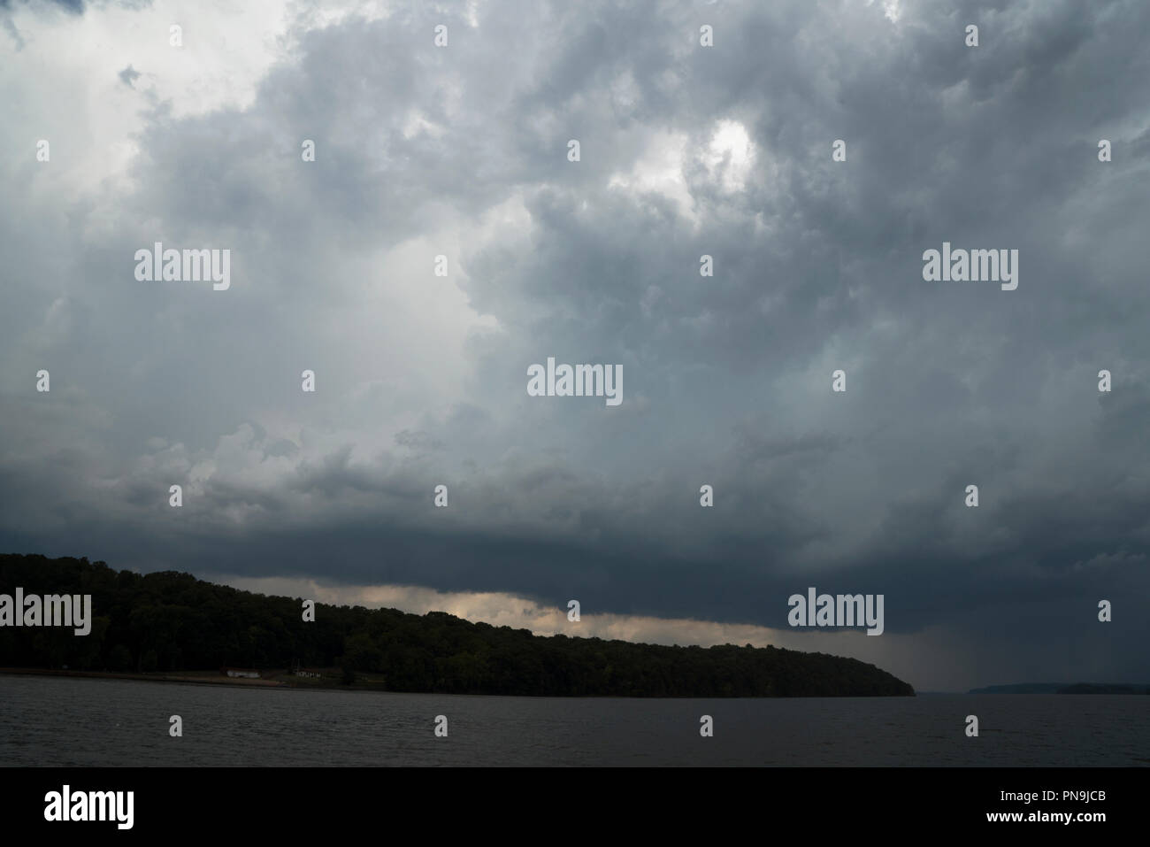 On a September afternoon, a storm bringing rain, thunder and lightning filled the sky over the Hudson River just south of the town of Hudson, New York. Stock Photo