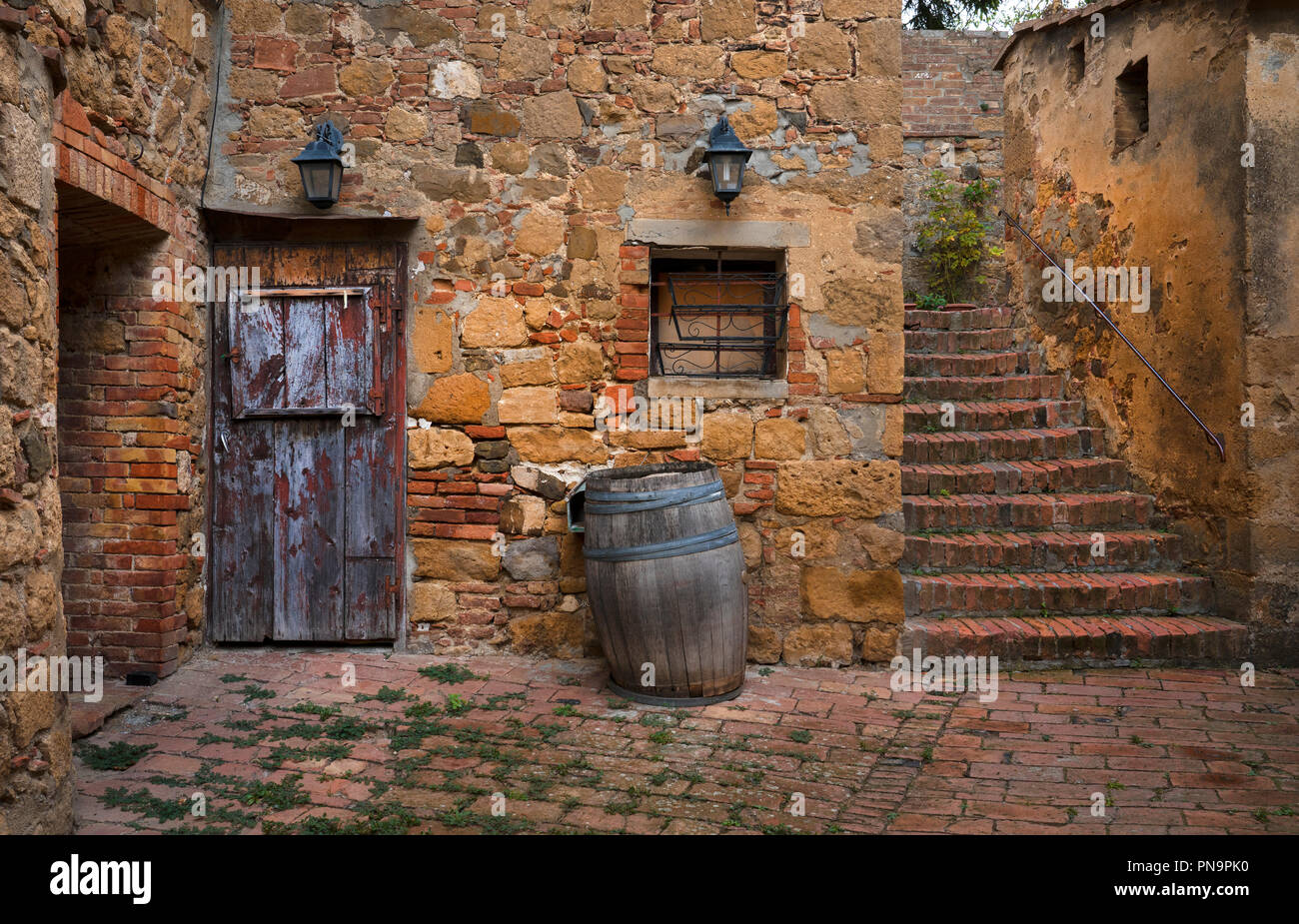 Old village scene with old wooden doors and barrels in village of Monicchiello,Tuscany,Italy Stock Photo