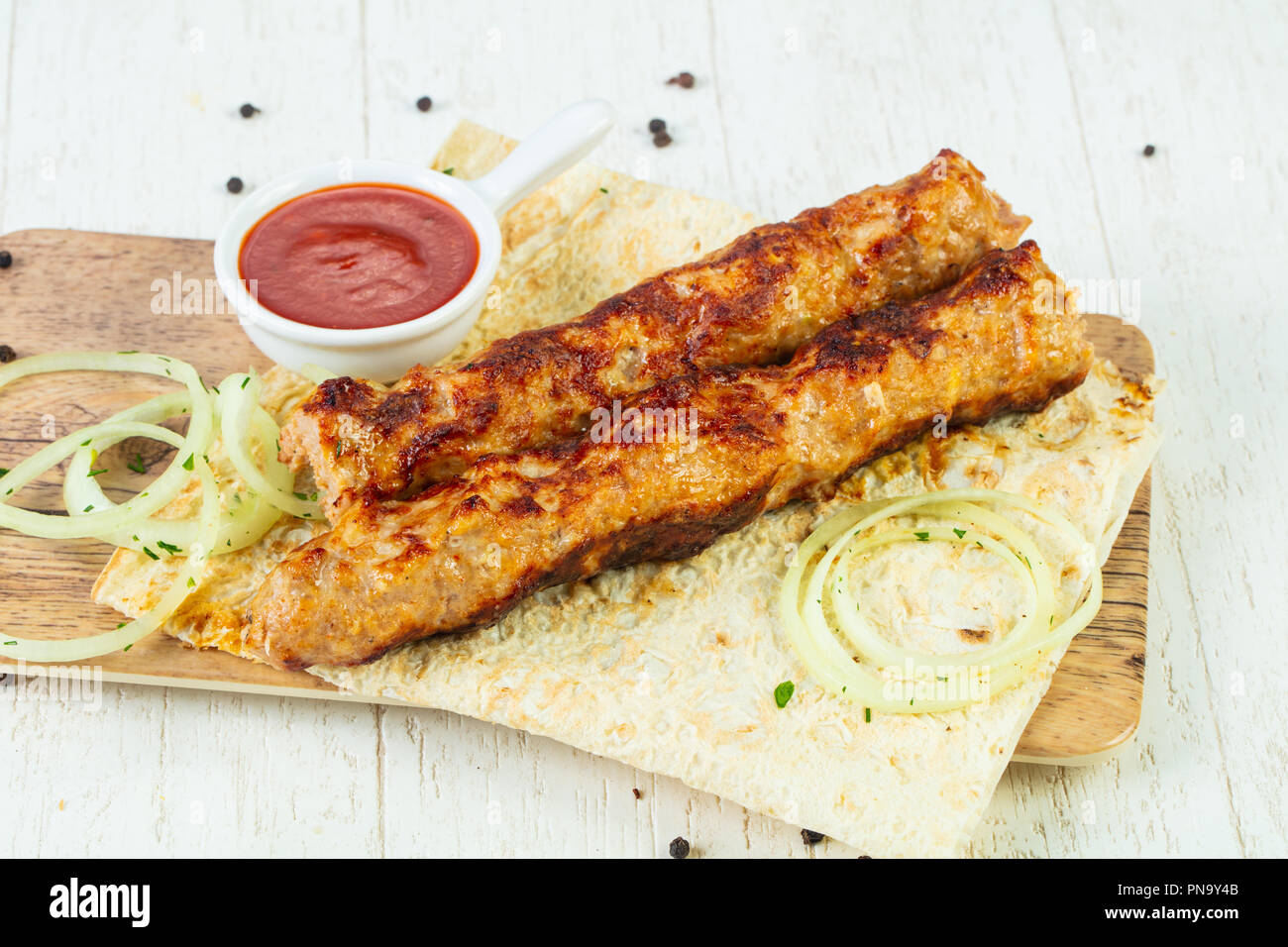 Grilled minced chicken kebab with sauce and onion Stock Photo Alamy
