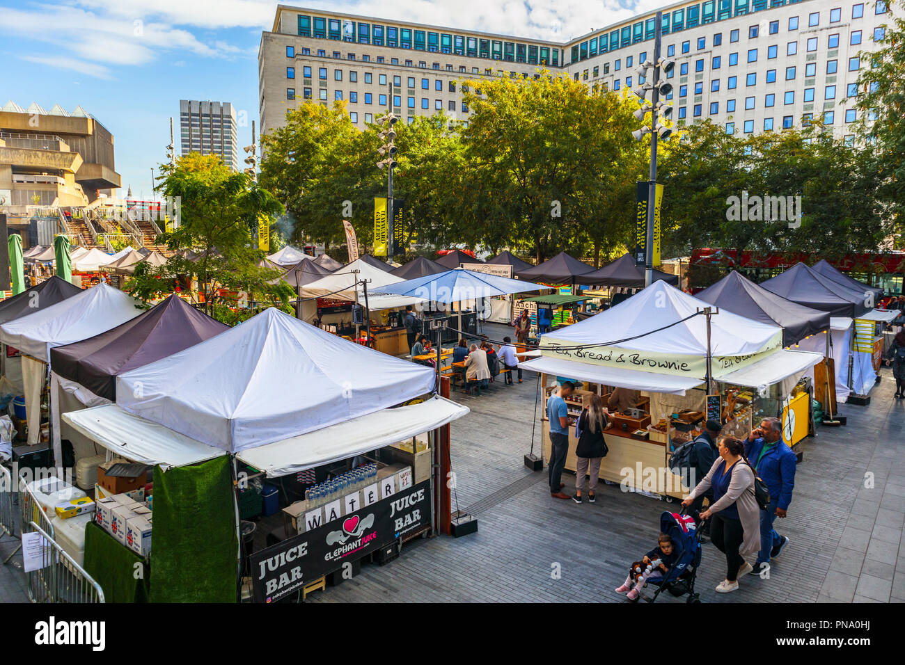 Popular food festival market on Belvedere Road by the Royal Festival Hall Southbank Centre on the South Bank, Lambeth, London SE1 on a sunny day Stock Photo