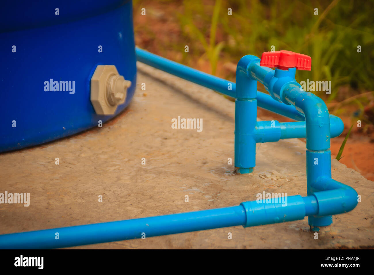 Red knob of PVC ball valve on the PVC pipe line in plumbing system for