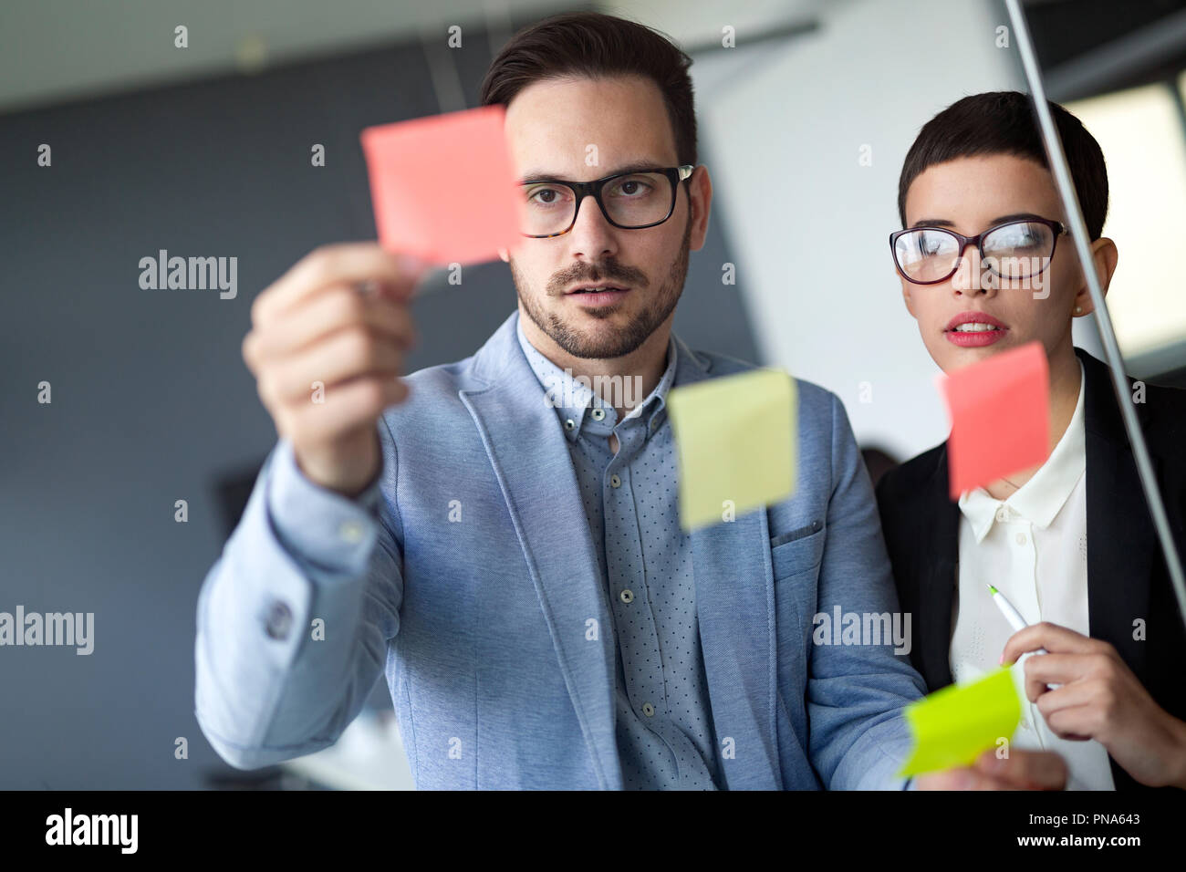 Business people meeting at office and use post it notes to share idea