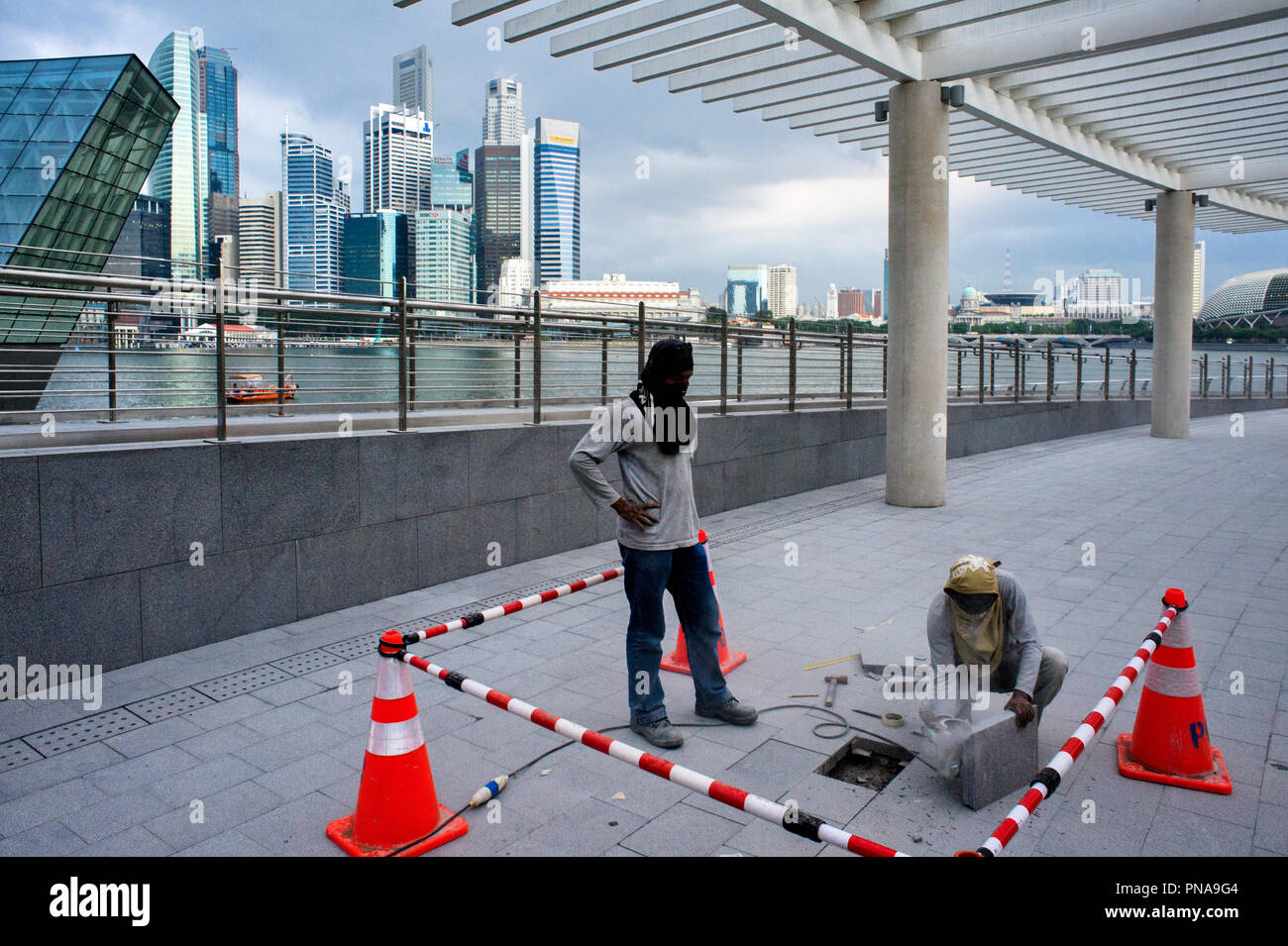 SINGAPORE – february 25, 2011 : finishes and repairs on slabs at the feet of the ArtScience Museum Stock Photo