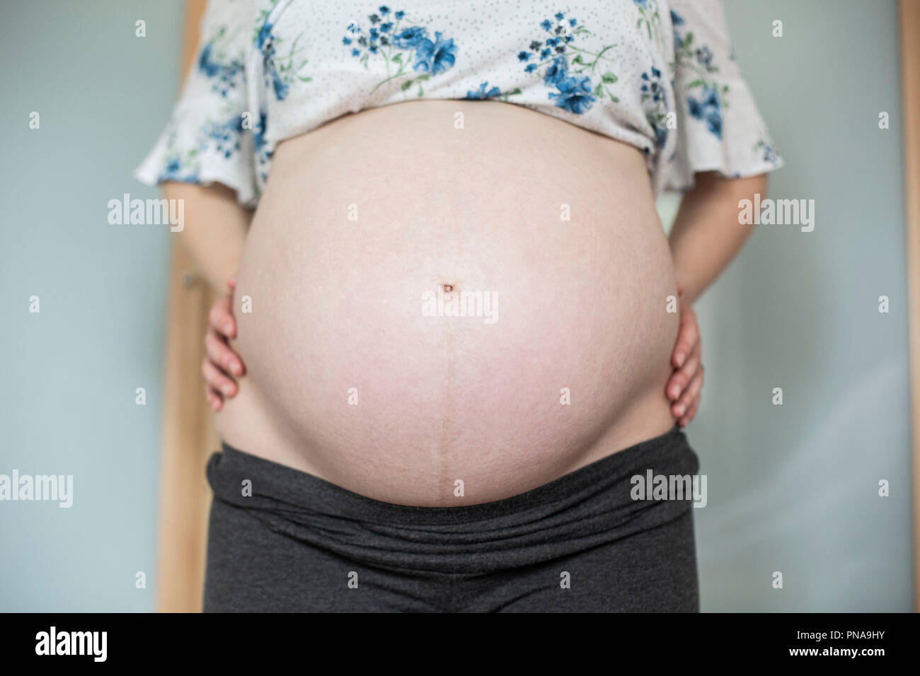 The swollen stomach of a heavily pregnant woman Stock Photo Alamy