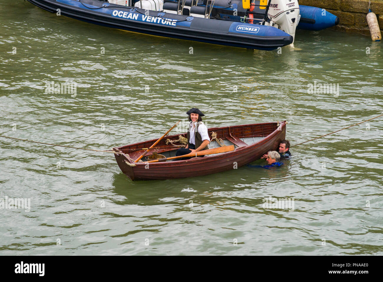 Editorial: UK Celebrities, Charlestown, Cornwall, UK 19/09/2018. Aiden Turner shares a joke while filming on the water in Charelstown. Stock Photo