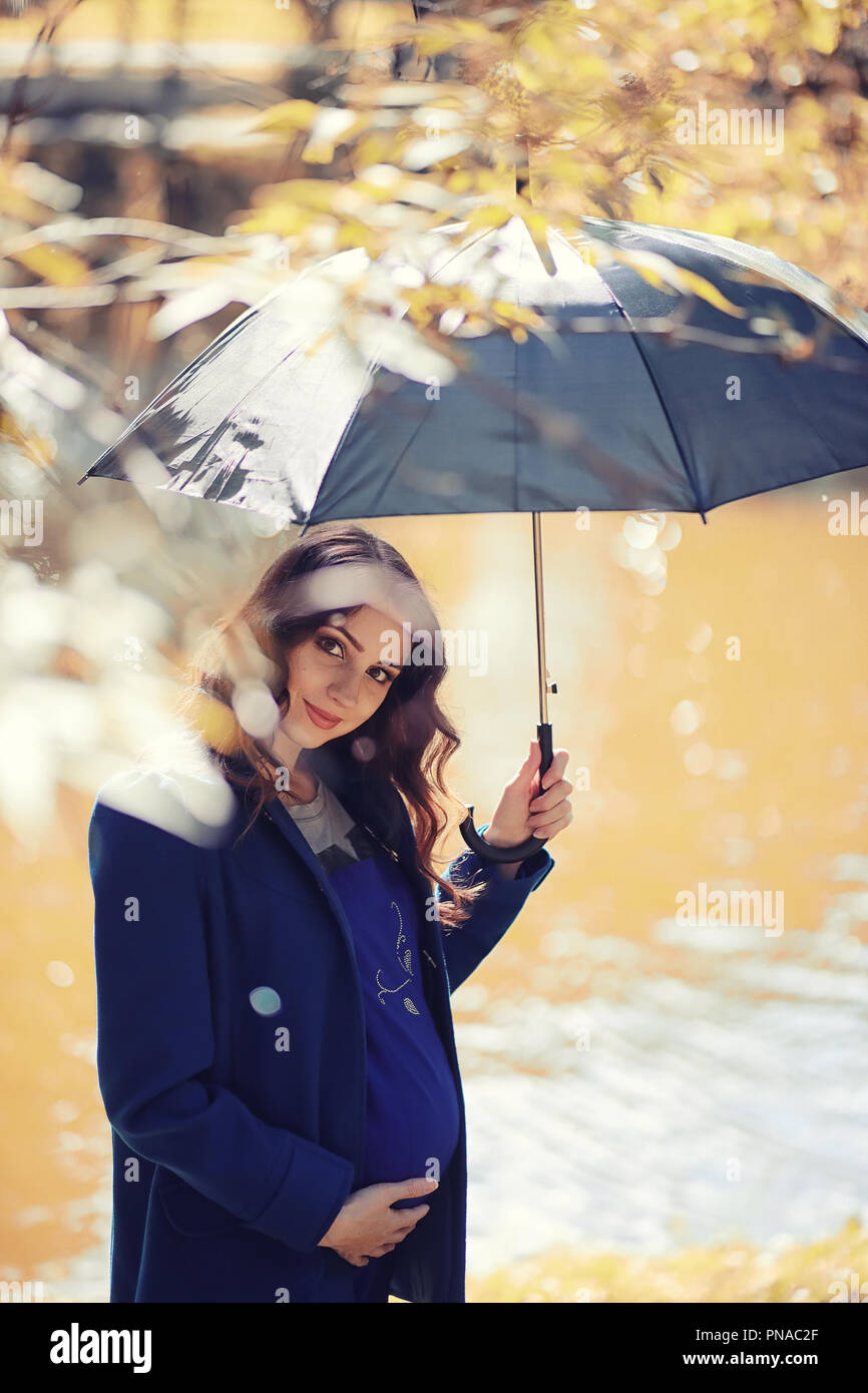 Pregnant woman on a walk in the park Stock Photo - Alamy