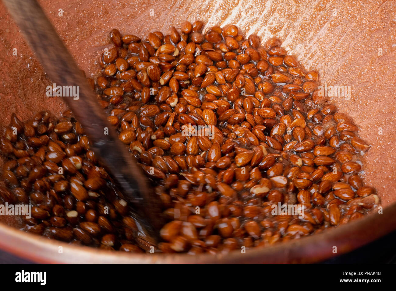Sugar coated almonds being hand roasted. Stock Photo