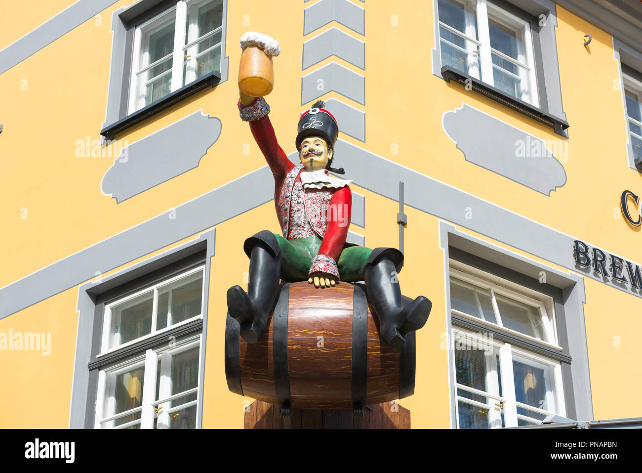 Beer sign, view of a sign in the form of a !8th century hussar raising a frothing stein of beer above a beer garden in Livu Laukums in Riga, Latvia. Stock Photo