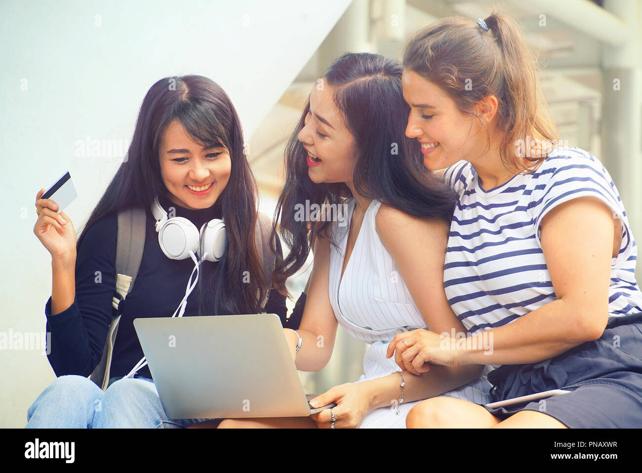 Three women sitting together and feel happy with shopping online Stock Photo