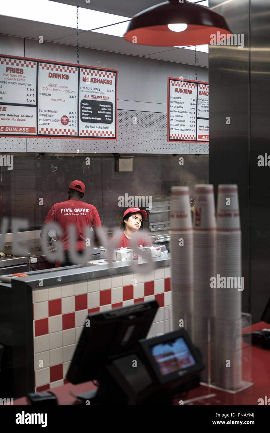 UK,London,West End - team members at work at  the Burger chain  'Five Guys' Stock Photo