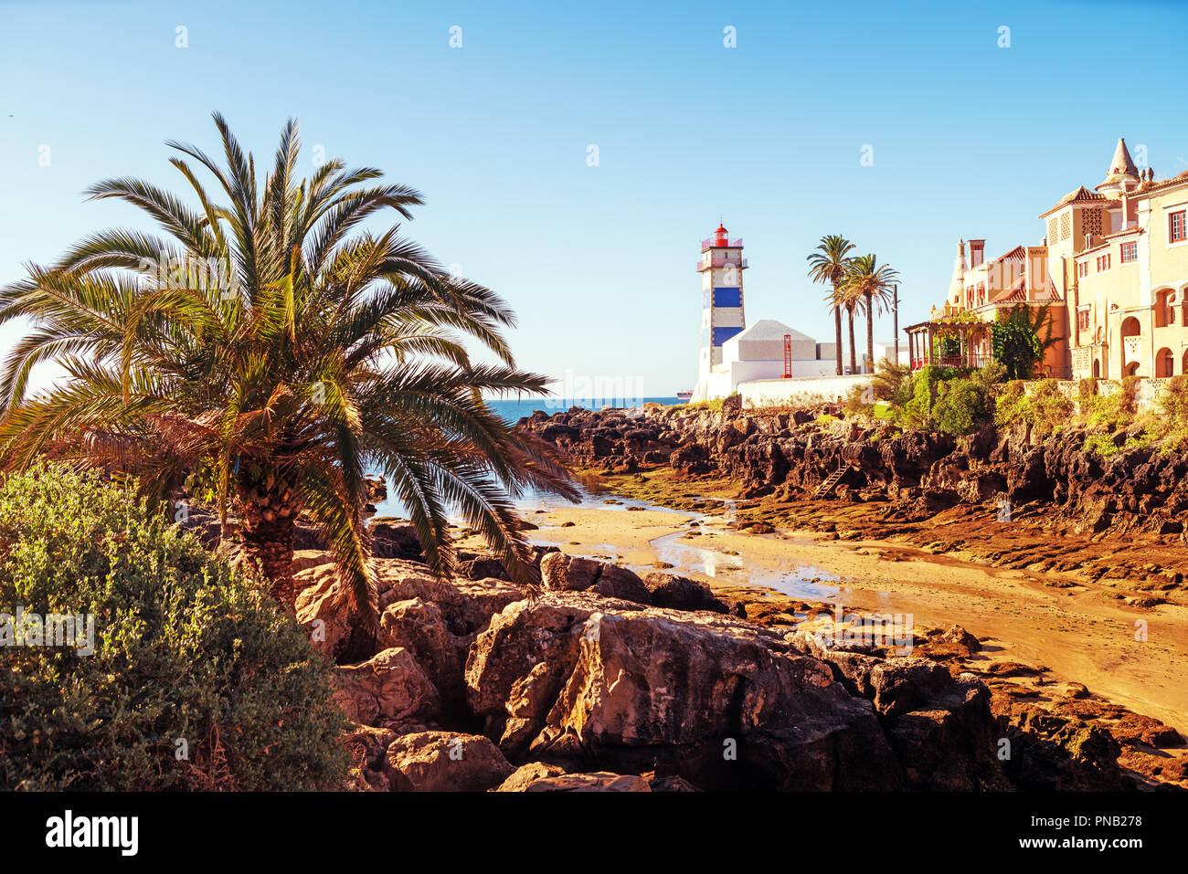 Santa Marta lighthouse and the Casa de Santa Maria in Cascais a Portuguese coastal town . Lisbon Portugal . Stock Photo