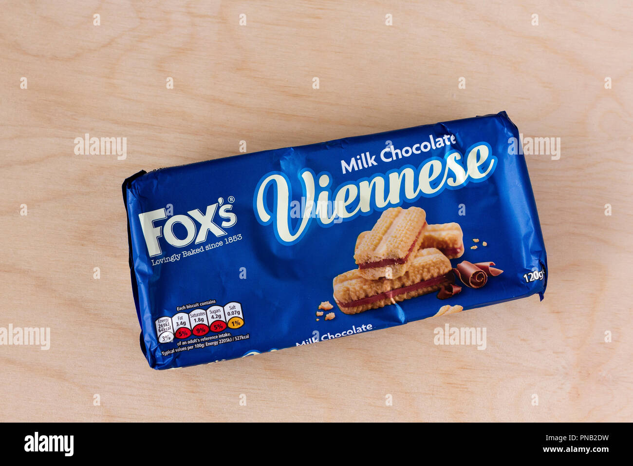 Foxs Viennese Milk Chocolate biscuits, unopened packet on a light wood background, United Kingdom Stock Photo