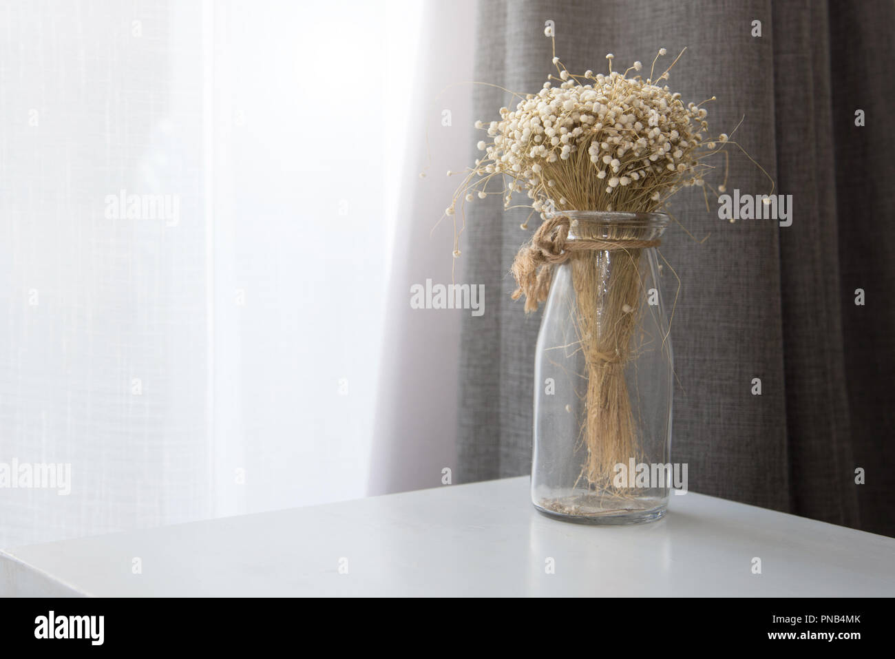 Dry Flower In Transparent Glass Vase Bottle At Living Room
