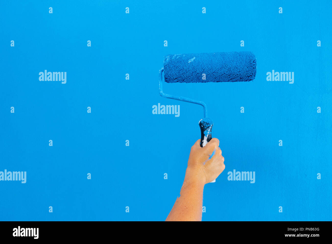 Someone painting wall Stock Photo