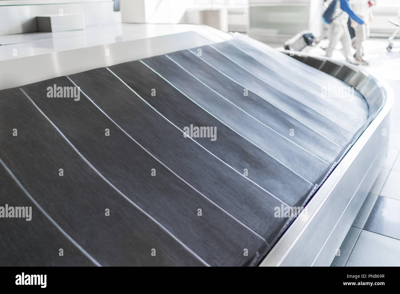 A Rotating Black Rubber Airport Baggage Claim Carousel Conveyor