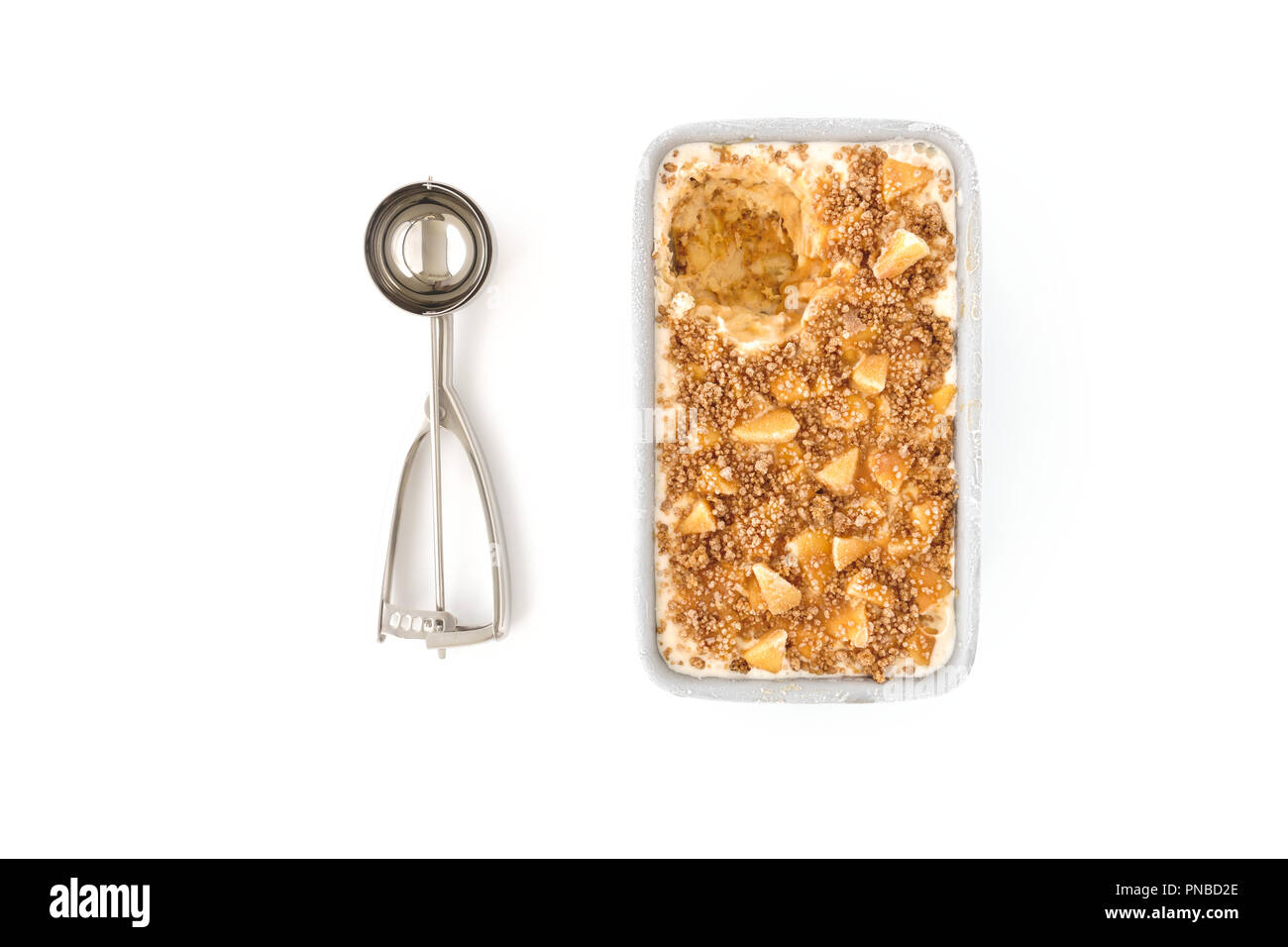 Homemade Toffee Apple Ice Cream in a metal container and an Ice Cream Scoop on white background. Stock Photo