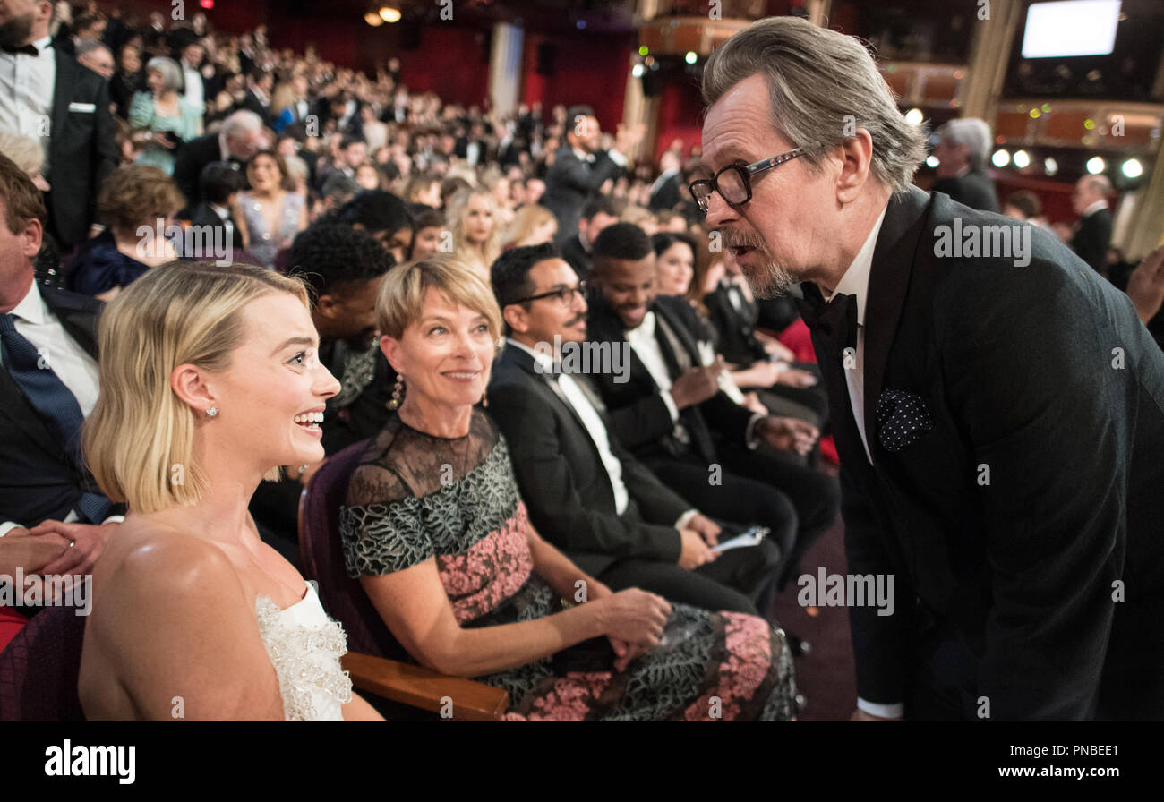 Oscar® nominees Margot Robbie and Gary Oldman greet each other during the live ABC Telecast of the 90th Oscars® at the Dolby® Theatre in Hollywood, CA on Sunday, March 4, 2018.  File Reference # 33546 476PLX  For Editorial Use Only -  All Rights Reserved Stock Photo