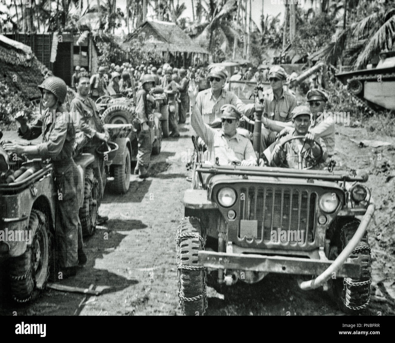1940s GENERAL MacARTHUR RIDING IN JEEP INSPECTS WAR IN THE PACIFIC THEATER TROOPS OCTOBER 29 1944 - asp fwp1942 ASP001 HARS PERSONS INSPIRATION UNITED STATES OF AMERICA MALES RISK CONFIDENCE TRANSPORTATION B&W FREEDOM SUCCESS WIDE ANGLE STRENGTH VICTORY STRATEGY COURAGE EXCITEMENT LEADERSHIP POWERFUL PROGRESS WORLD WARS PRIDE WORLD WAR WORLD WAR TWO WORLD WAR II AUTHORITY OCCUPATIONS TROOPS UNIFORMS CONNECTION STYLISH WORLD WAR 2 29 OCTOBER TOGETHERNESS 1944 BLACK AND WHITE CAUCASIAN ETHNICITY OLD FASHIONED Stock Photo