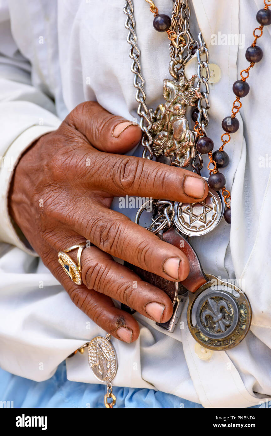 Detail of hands holding religious symbols during a popular festival in Brazil in honor of Saint George Stock Photo