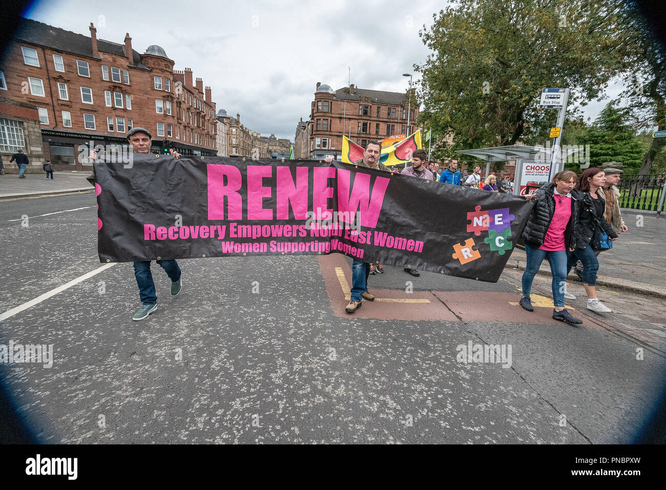 A group of members seen holding a banner that reads RENEW during the
