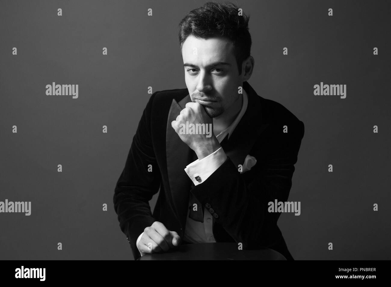 Portrait of a young handsome man in a dinner jacket, bow tie undone