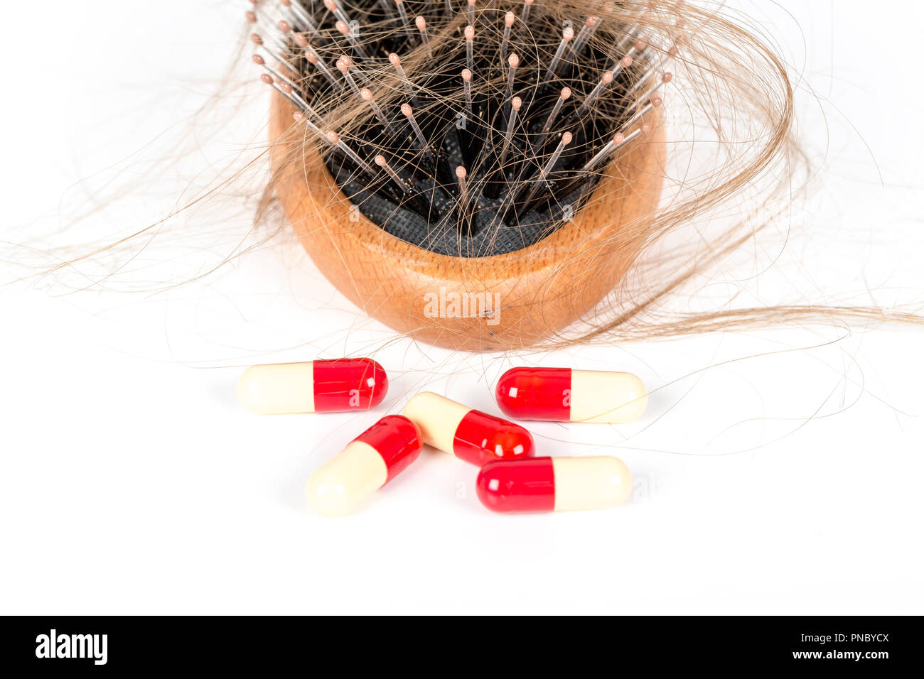 Wood Hairbrush On White Background Close Up With Long Brown Hair