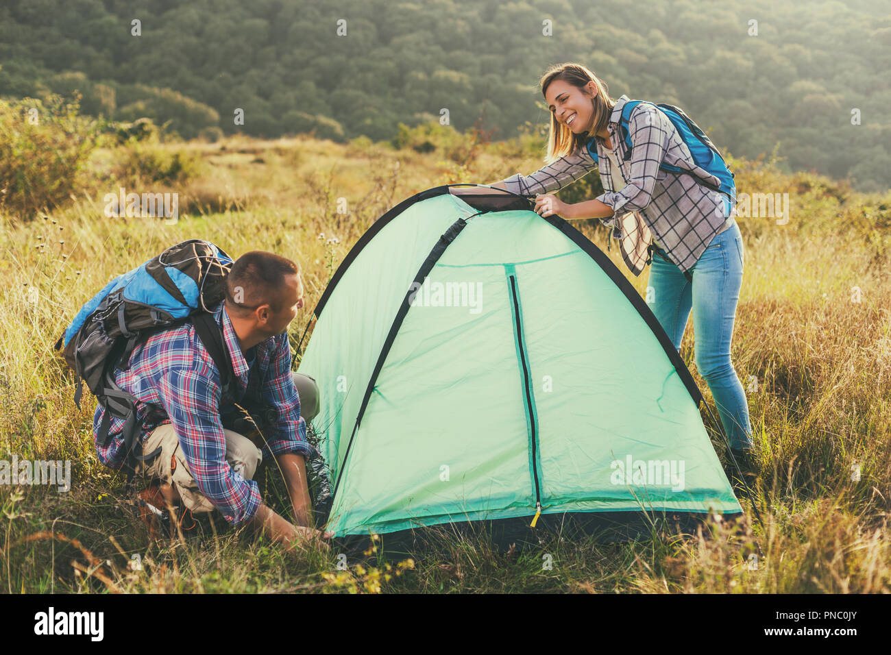 Happy couple is camping in mountain. Stock Photo