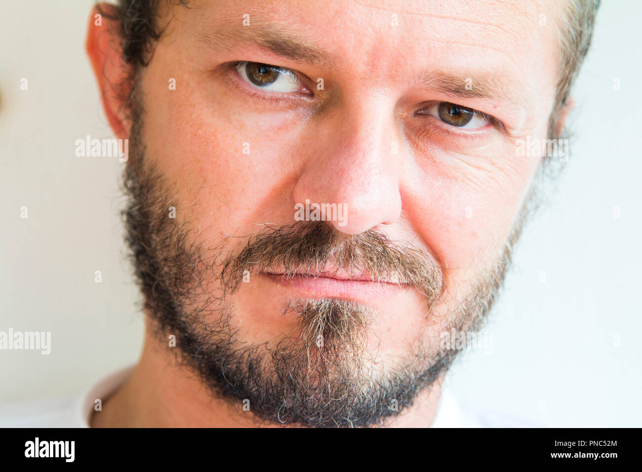 Man with beard and mustaches, skeptic and mean expression Stock Photo