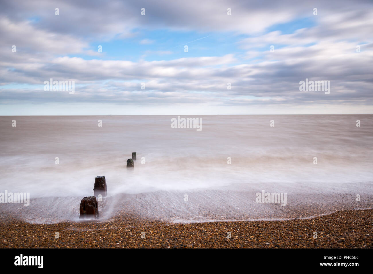 Minimalistic long exposure looking out to sea at Bawdsey, Suffolk, UK. Frame contains a lot of empty space Stock Photo