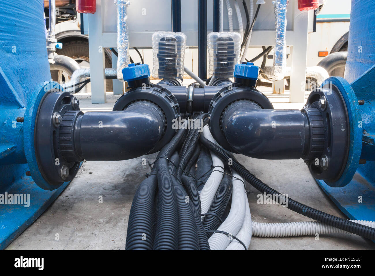 Black communication pipes with valves and black hoses Stock Photo Alamy