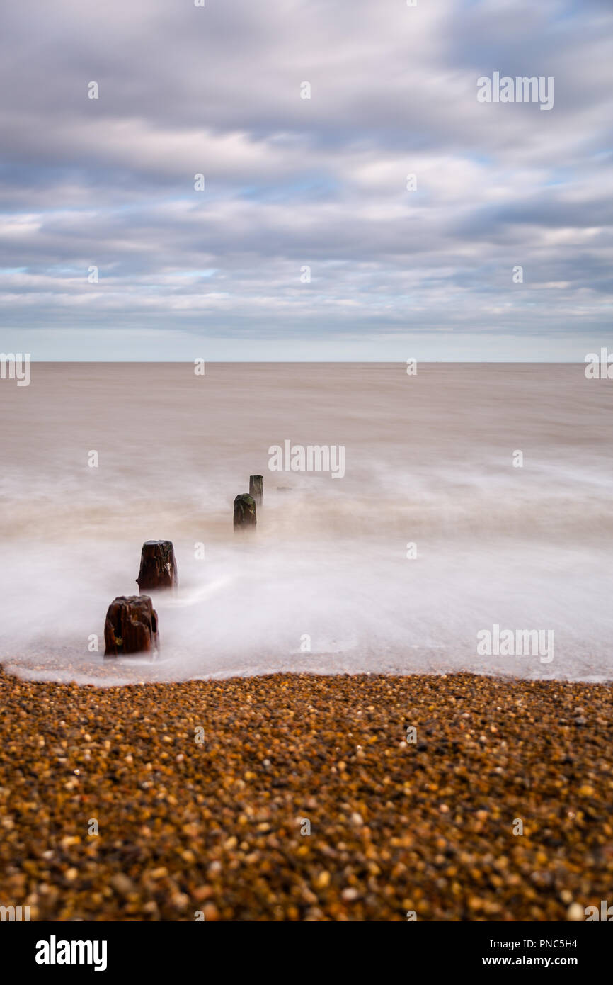 Minimalistic long exposure looking out to sea at Bawdsey, Suffolk, UK. Frame contains a lot of empty space Stock Photo