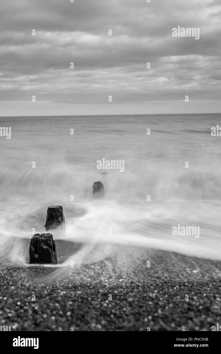 Minimalistic long exposure looking out to sea at Bawdsey, Suffolk, UK. Frame contains a lot of empty space Stock Photo