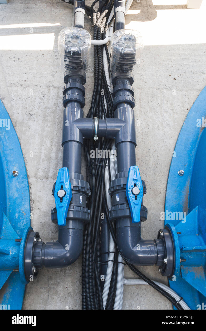 Black communication pipes with valves and black hoses Stock Photo Alamy