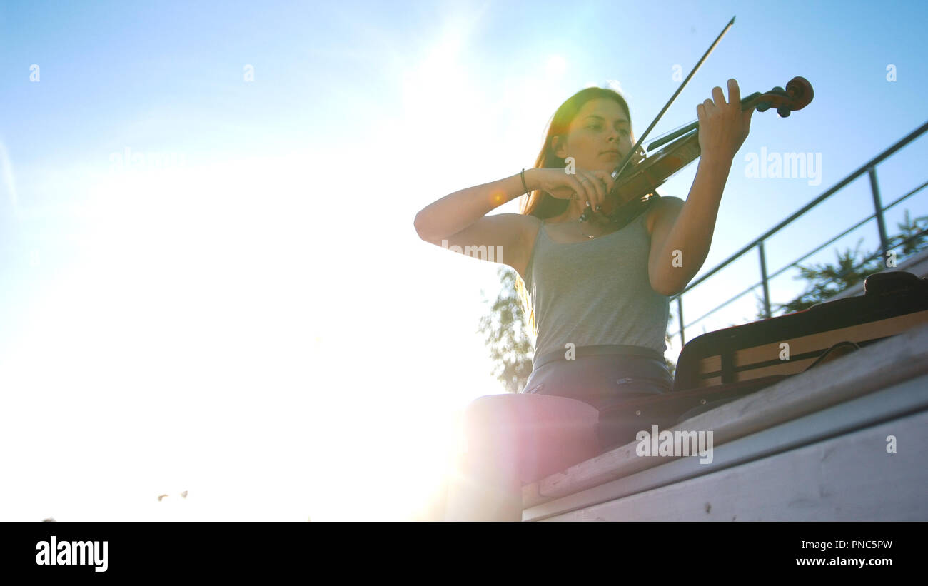 Young girl playing the vintage violin on the nature Stock Photo - Alamy