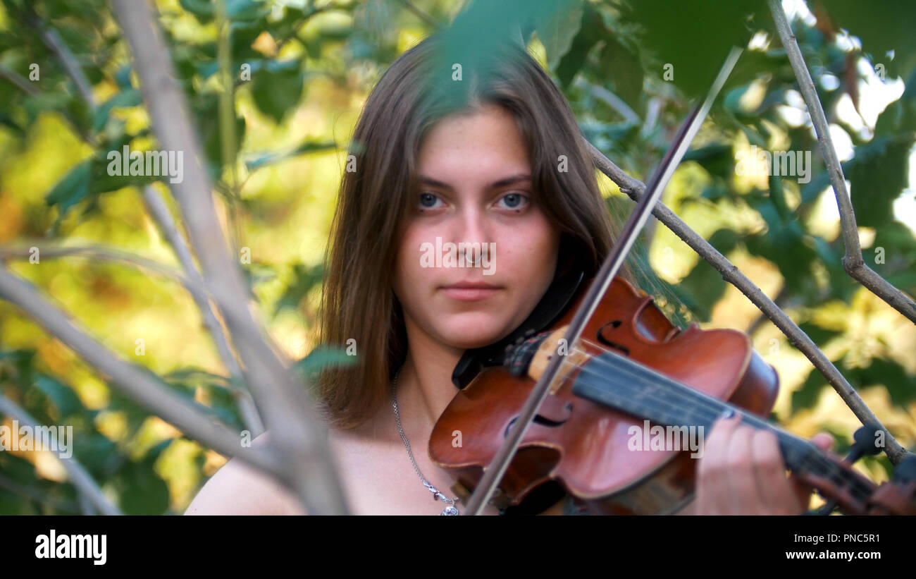 Young girl playing the vintage violin on the nature Stock Photo - Alamy