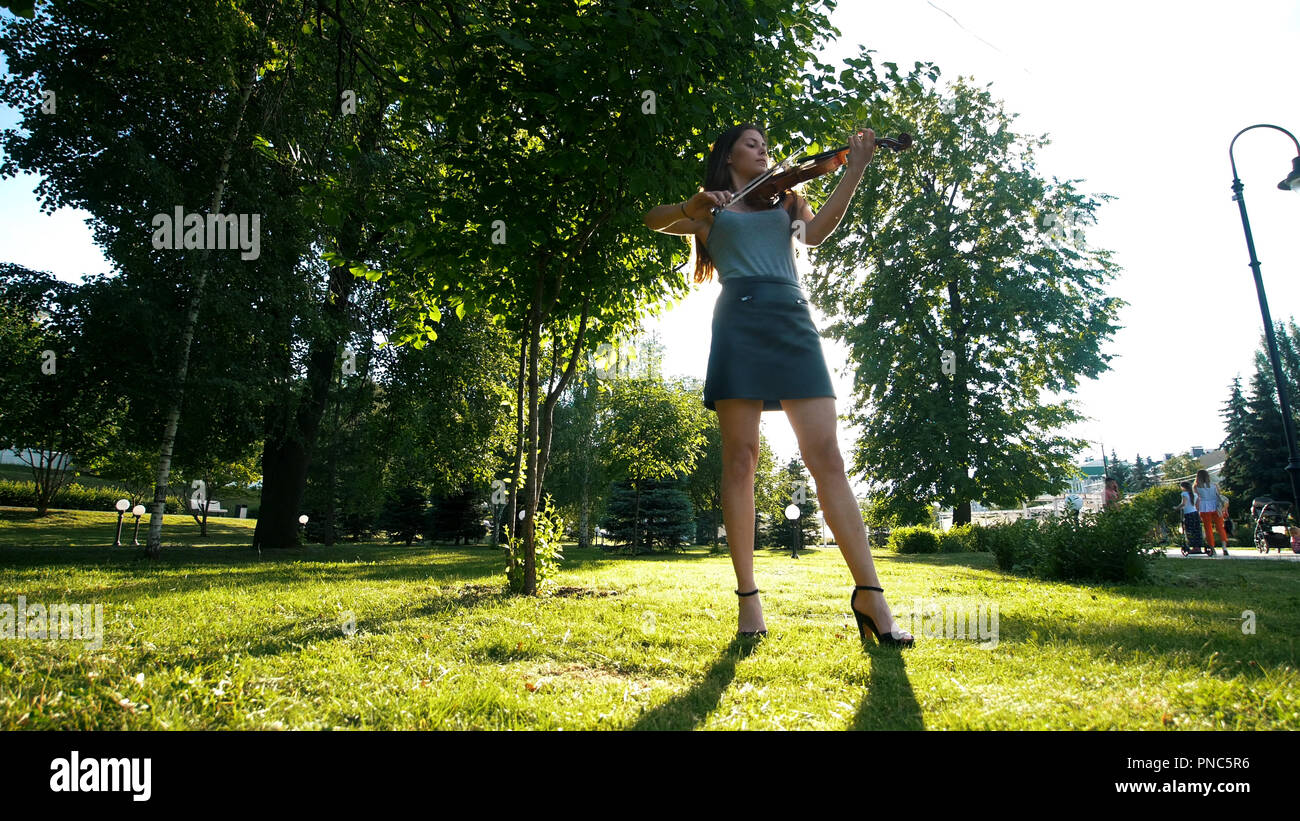 Young girl playing the vintage violin in the park Stock Photo - Alamy