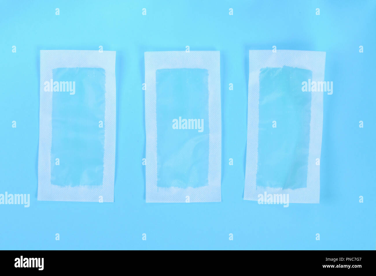 Blue Waxing Strips On Blue Pastel Background Top View Stock Photo