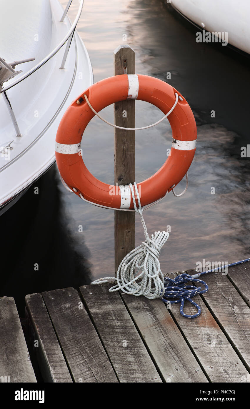 Life buoy on wooden dock with natural look. Stock Photo